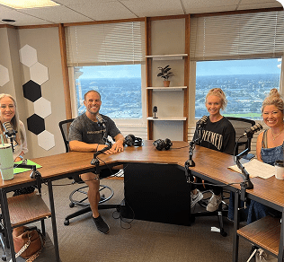 Friends chatting around a podcast table