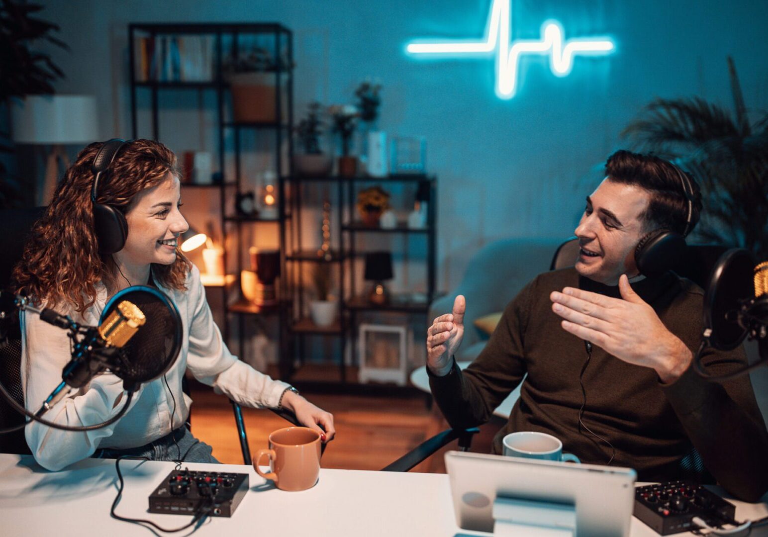Two friends enjoying drinks and music in a cozy room.