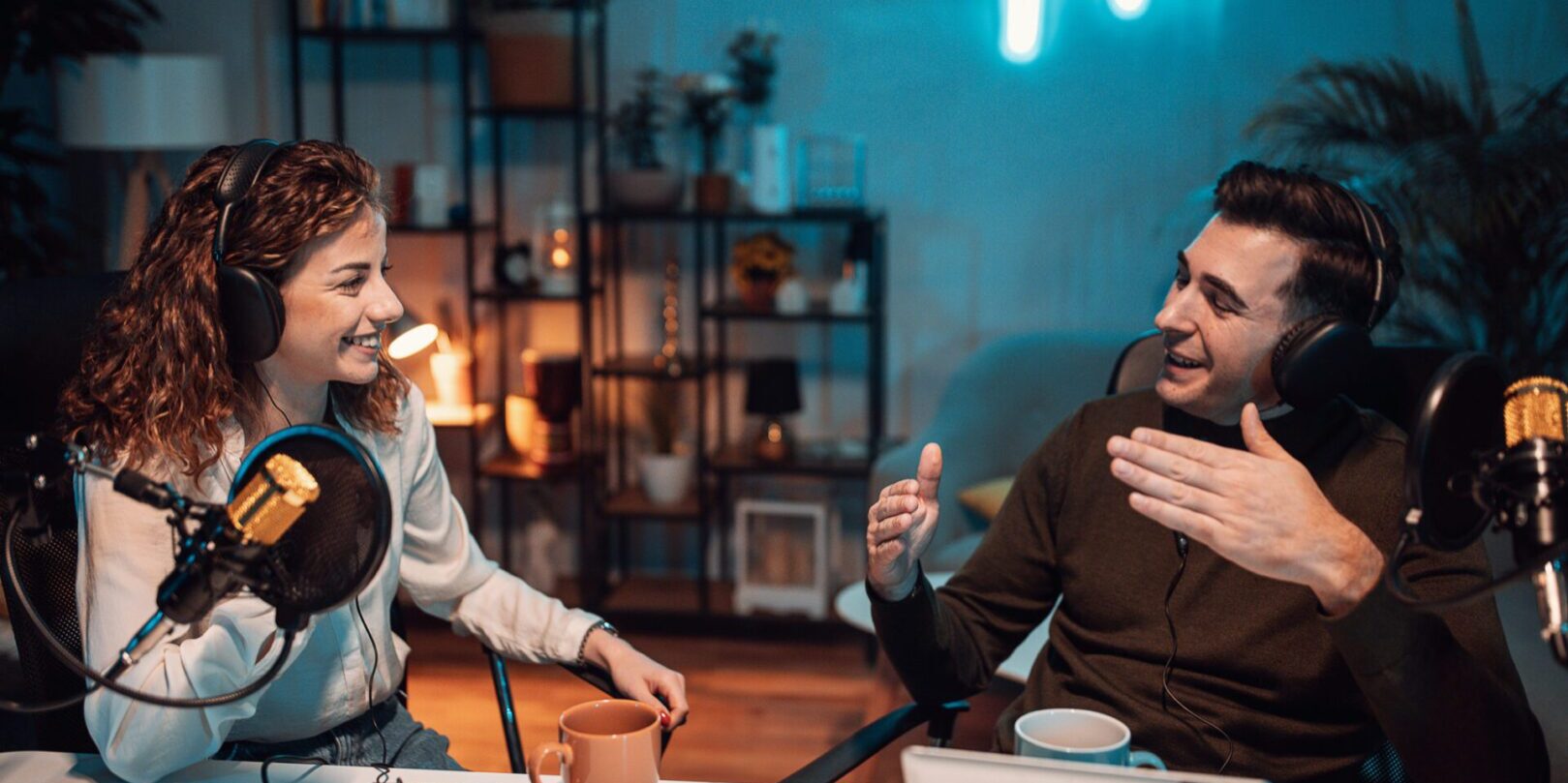 Two friends enjoying drinks and music in a cozy room.